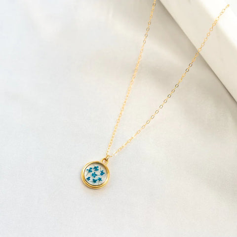 september birth flower, aster, pressed in small charm on a gold filled necklace