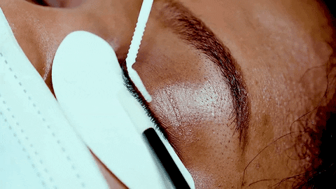 Applying lash booster to the lashes