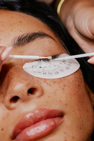 Applying lash primer to the lashes