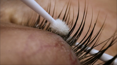 Applying lash primer to the natural lashes in preparation for eyelash extensions
