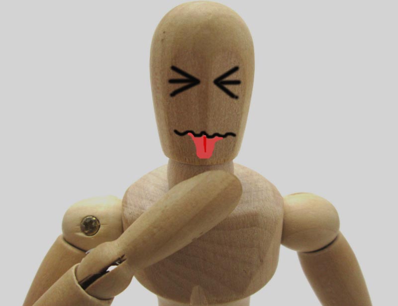 Wooden figure with sour face