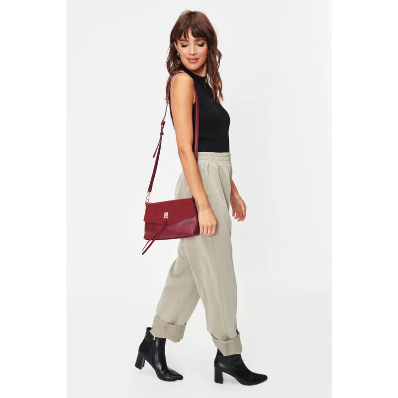 woman carrying minimalist vegan leather crossbody