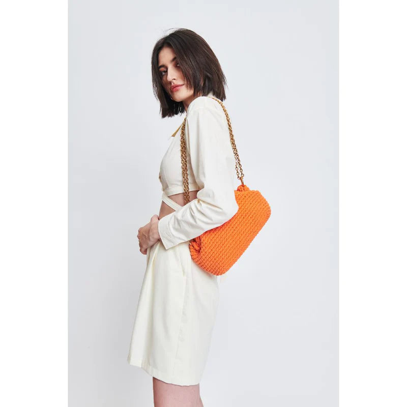 woman wearing an orange canvas crossbody handbag