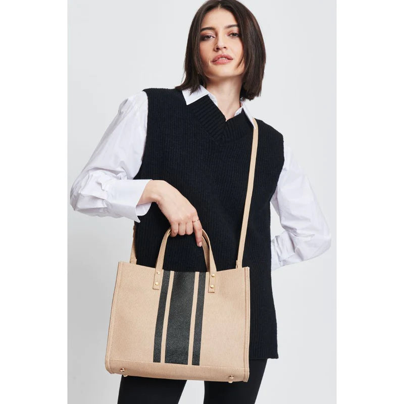 woman carrying vegan leather snap tote