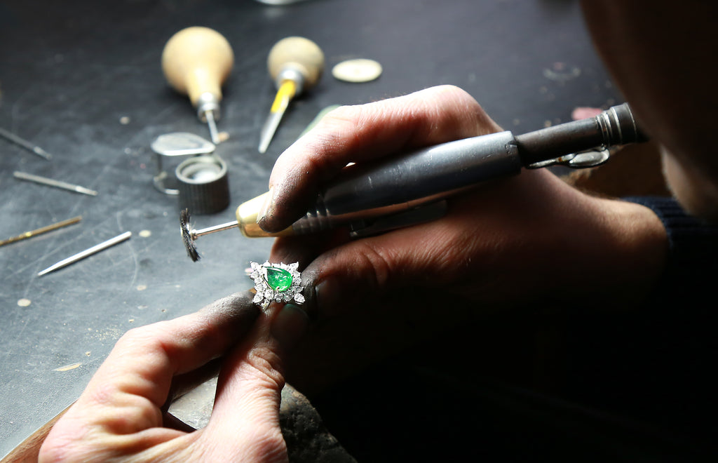 A jeweler sets an emerald ring - Assay Jewelers