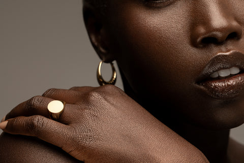 Ethically sourced Fairmined gold jewelry on a Black model.