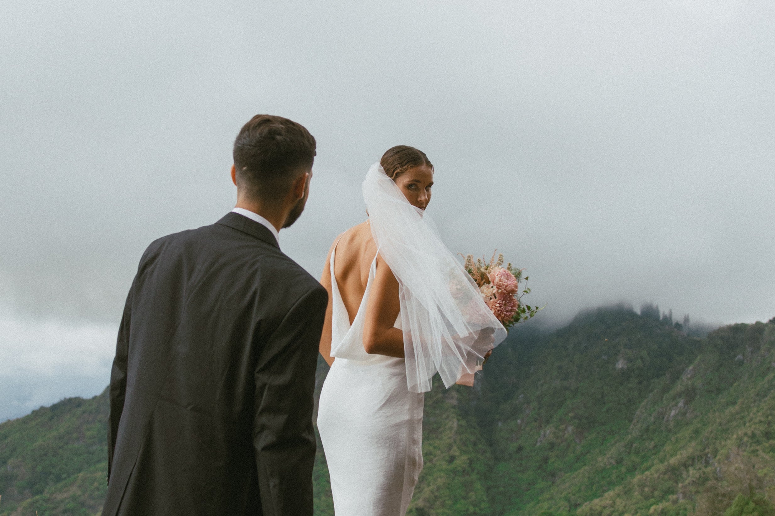 Bride and Groom walking on ridgeline of Palehua on Oahu