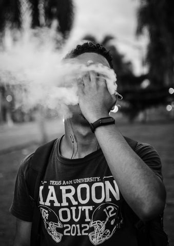guy with hand on face while vaping