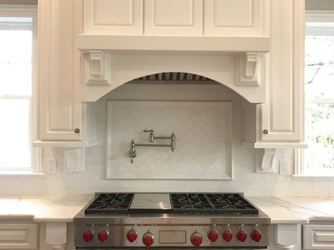 White kitchen with herringbone pattern backsplash