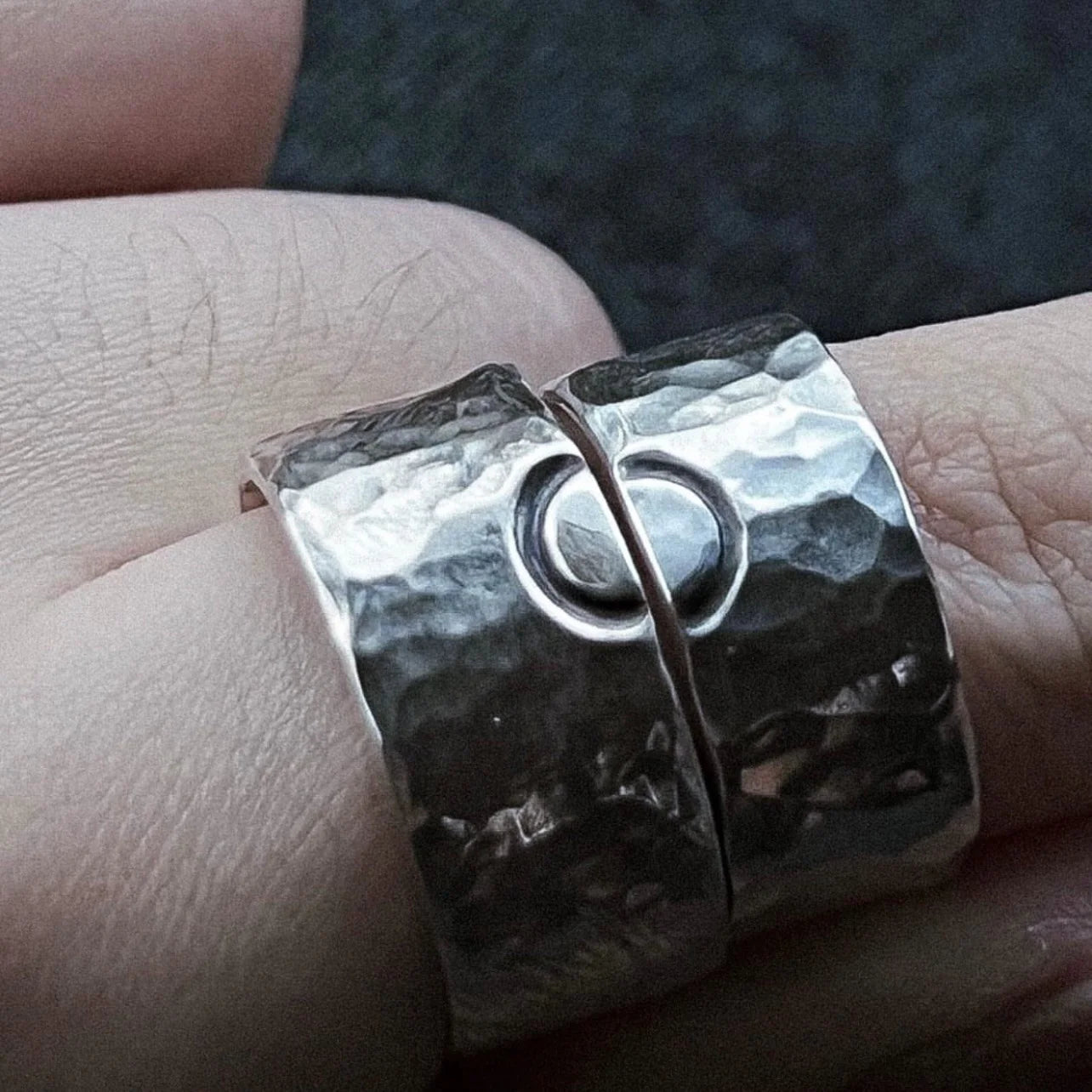 Silver rings with connecting circle symbol, textured band base