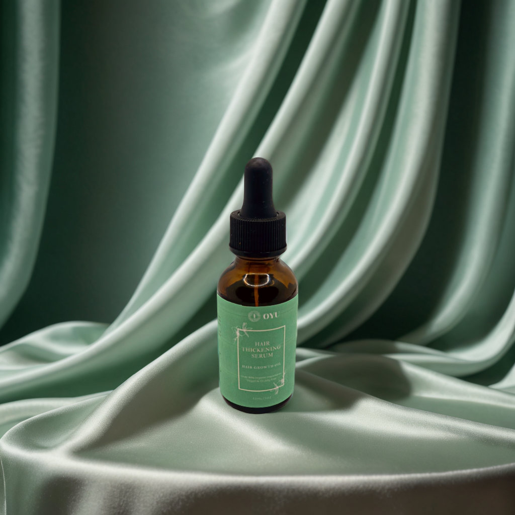 OYU's Hair Thickening Serum: Amla oil, argan oil, and nettle leaf extract in a floral setting, promoting hair growth, preventing breakage, and protecting the scalp.