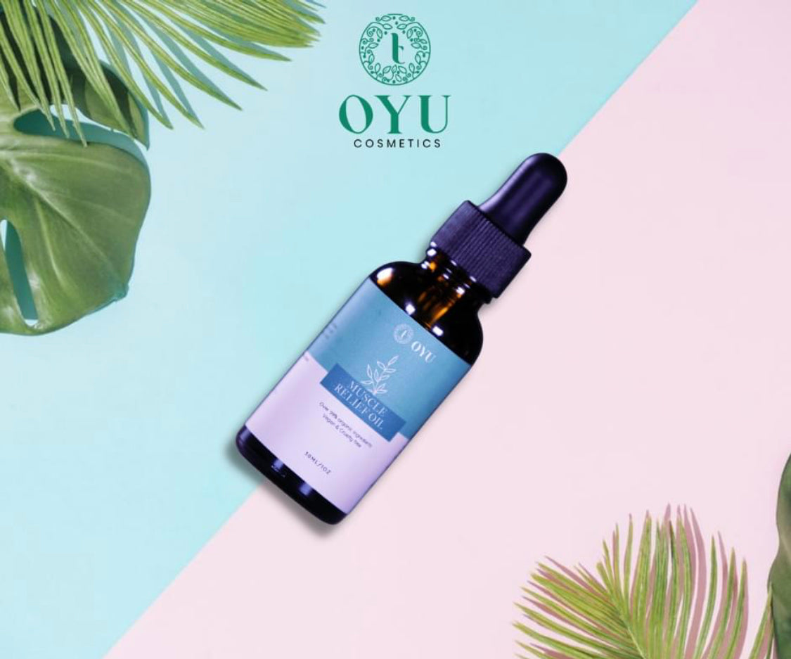 "OYU Cosmetics Muscle Soreness Relief Oil: A bottle of rejuvenating oil set against a backdrop of pink and blue hues, floating amidst ethereal clouds, offering relief from muscle soreness."