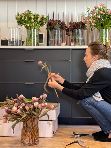 Britt Summers, co-founder of the hōm market prepping flowers