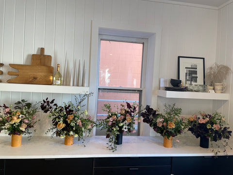 five floral arrangements by students at the hōm market