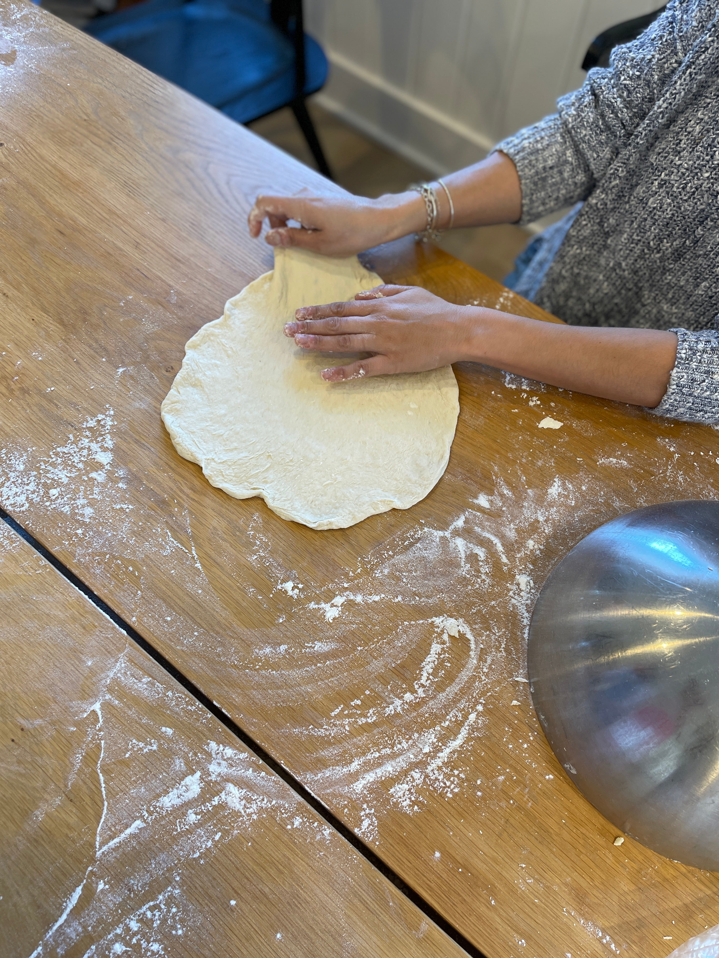 Pizza dough gently stretched into a round