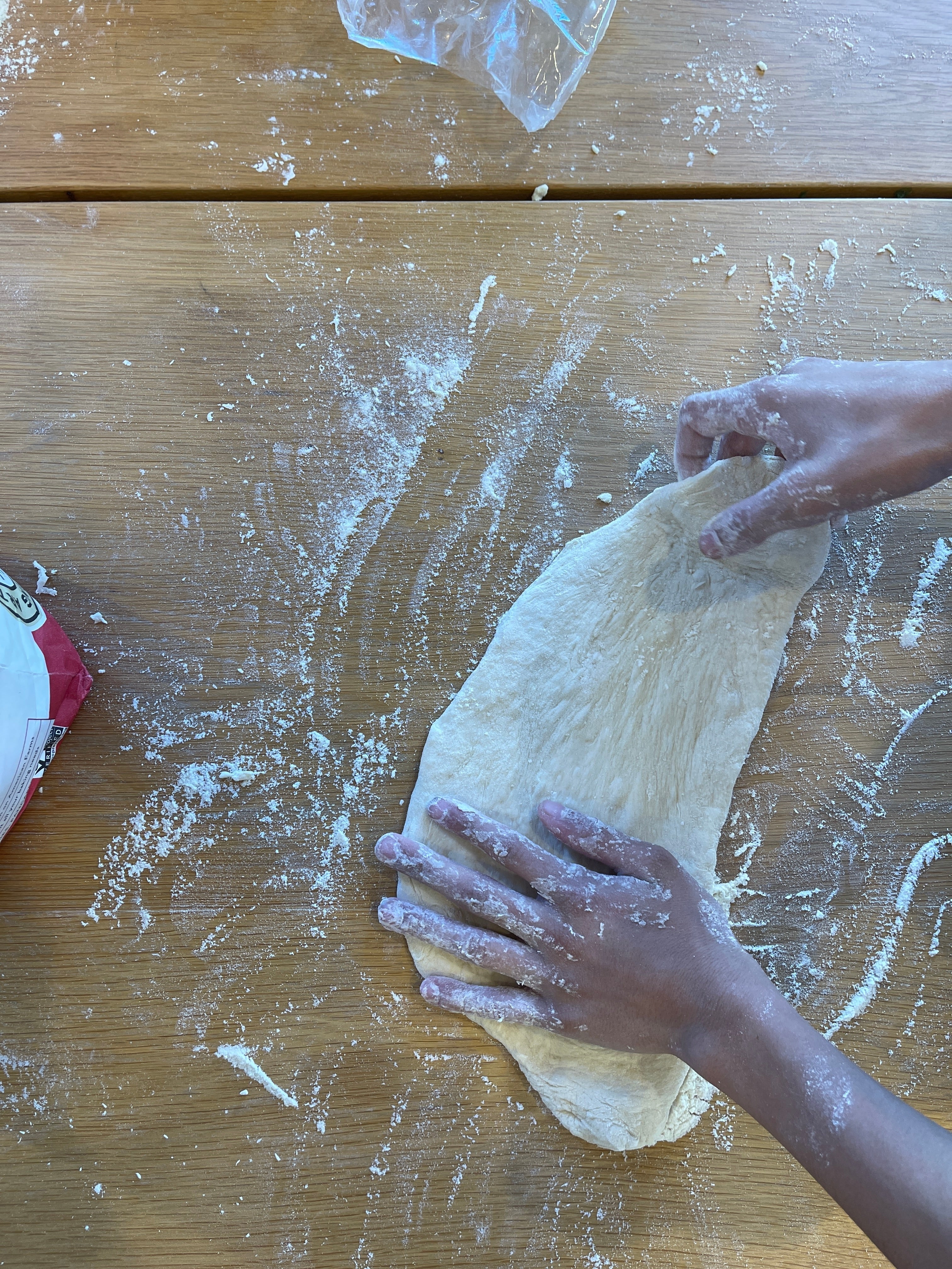 Gently stretching pizza dough