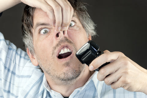 Man trimming his nose hairs