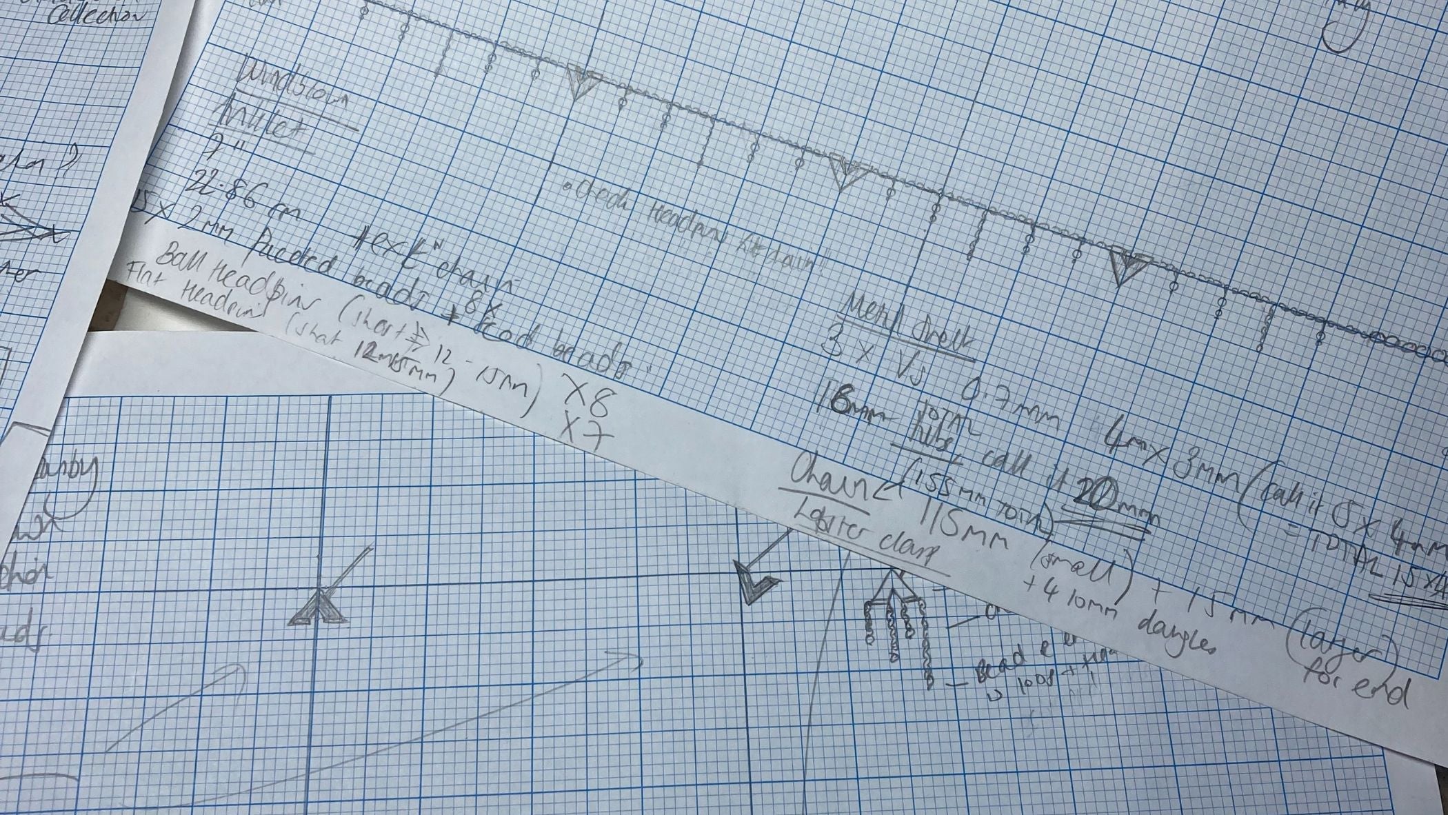 Sketches on graph paper of newly designed earring studs and anklets, which are soon to be part of the Windblown collection.