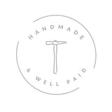 Logo for #handmadewellpaid campaign, hammer in a circle with 'HANDMADE & WELL PAID' around the edge in taupe writing