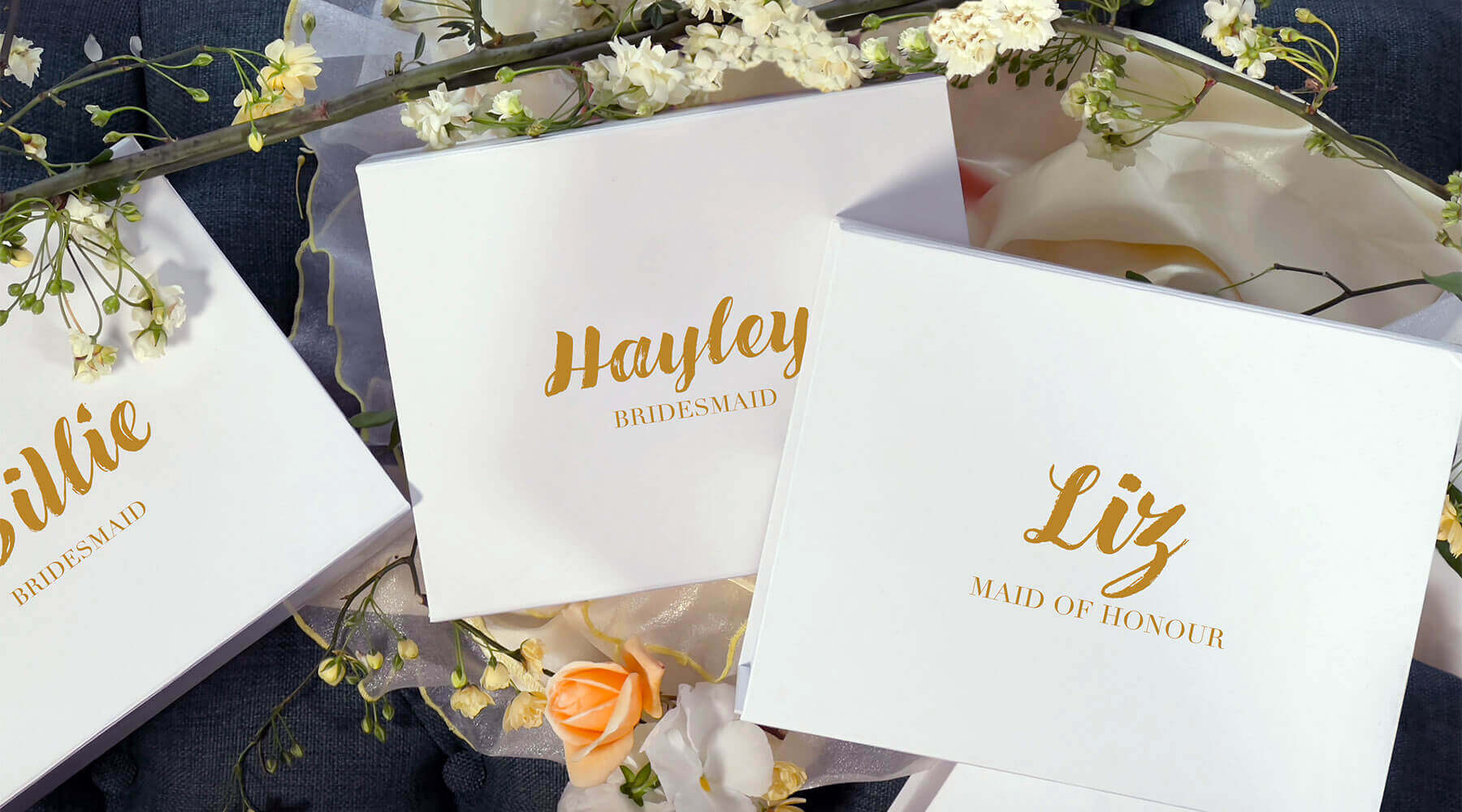 3 white wedding boxes with names on it