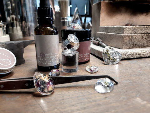 Naturkosmetikprodukte von Rosas und Schmuck von made-tohuus auf einem Werktisch