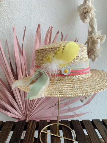 A trendy hat designed with ribbons and embellishments at a hat bar party from dWELLing Home Decor and Apparel