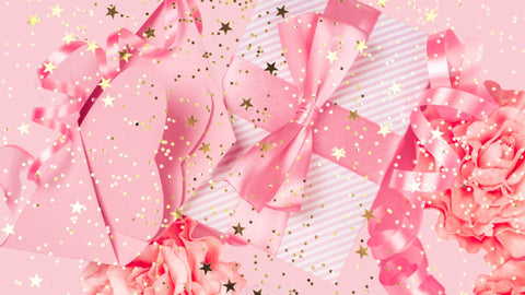 The image features a colorful banner surrounded by confetti and balloons. In the center of the banner, there is an image of a gift box, wrapped in shiny paper and topped with a bow.