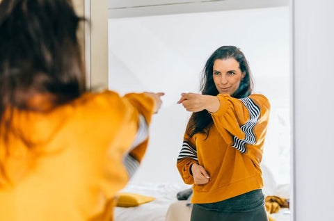 Confident woman in front of the mirror