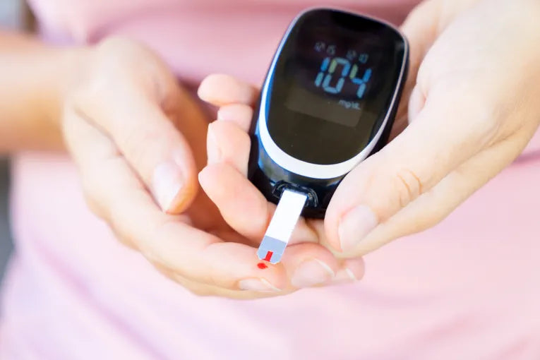 women with diabetes taking her blood sugar levels with a device
