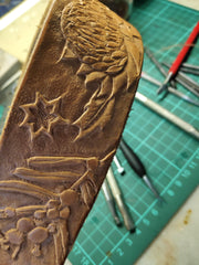 Hand tooled and painted with Australian native plants and dog name. Re-used buckle to help environment. Veg tanned leather