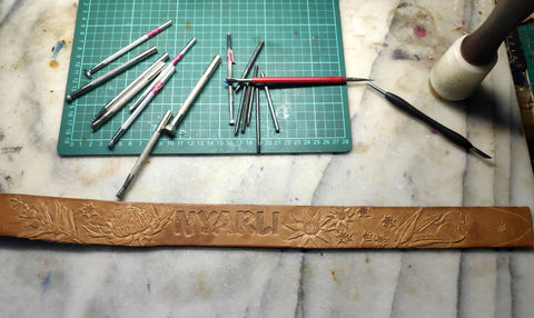 Hand tooled and painted with Australian native plants and dog name. Re-used buckle to help environment. Veg tanned leather