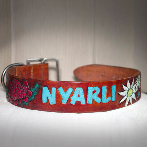 Hand tooled and painted with Australian native plants and dog name. Re-used buckle to help environment. Veg tanned leather