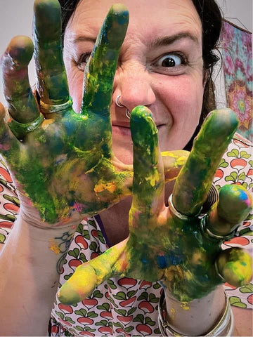 Tasmanian Artist Sandi heilbronn aka Wild Mama Kin with paint on her hands