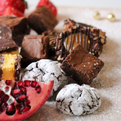 Trove Desserts handmade charcuterie grazing style dessert display including fudge brownie, turtle cookies, chocolate crinkle cookies, nanaimo bars, and pomegranate