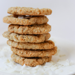 Trove Desserts stack of handmade Coconut Oatmeal Cookies on a bed of coconut