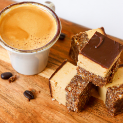 Trove Desserts handmade cappuccino Nanaimo bar made with a shot of Vancouver's JJ bean espresso displayed on a wooden charcuterie board