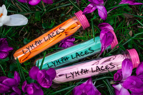 Three test tubes with Lymph Laces in different colors