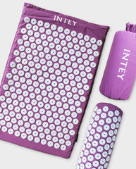 A purple cloth mat with numerous plastic spikes