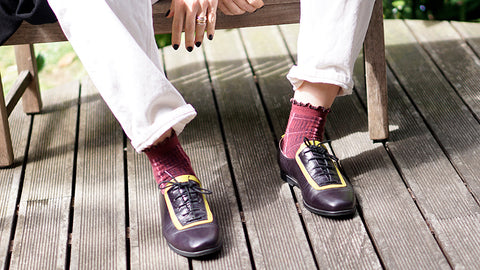 women wearing black leather shoe