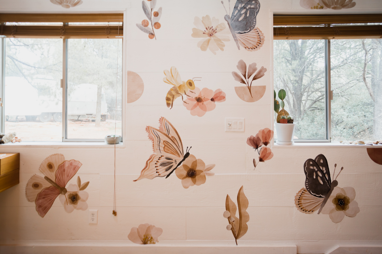 white wall with butterfly wall decals applied to it