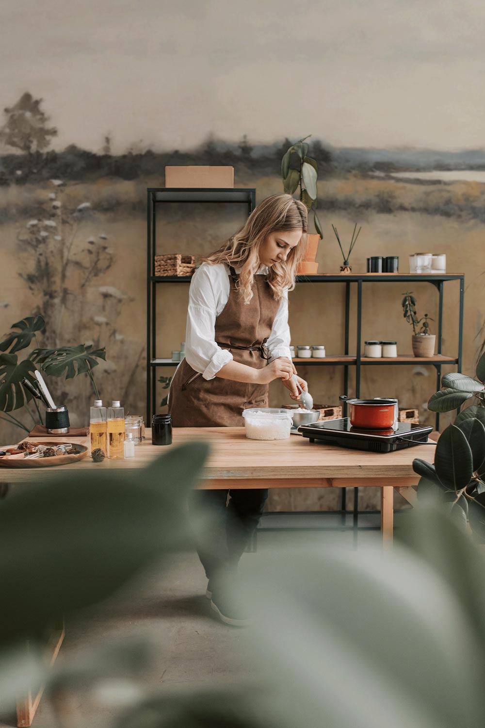 Riverside Wall Mural showcased in workshop behind a girl working.