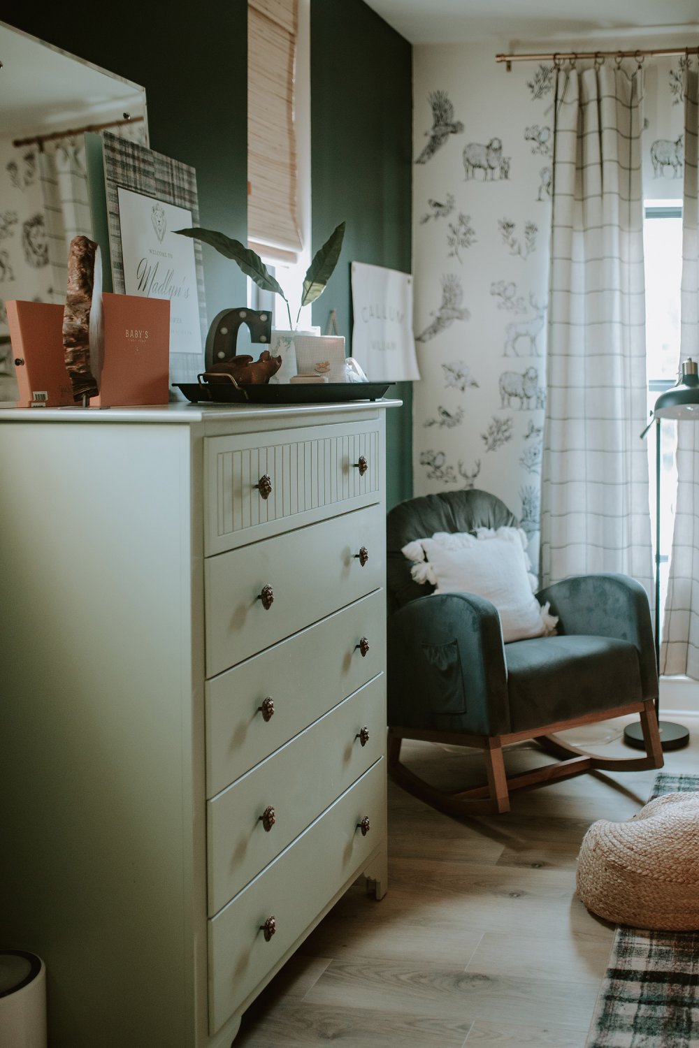 deep green walls and complimentary sage dresser with black and white wall decals