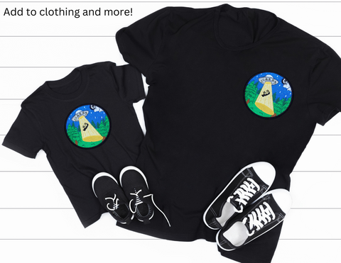 Image shows our UFO cow abduction patch on both a childrens and adult black t shirts