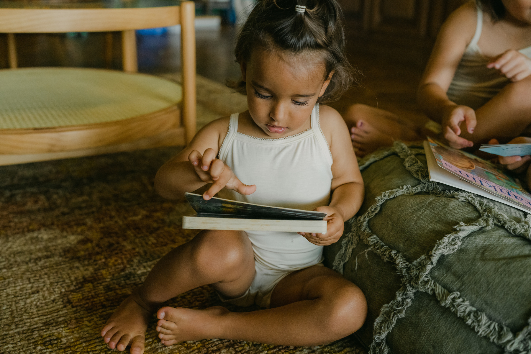 Image shows a girl reading a book, wearing Just Peachy TENCEL Modal Kids Underwear. TENCEL Modal is recommended for children with sensitive, eczema prone skin.