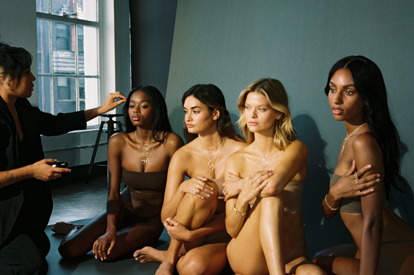 4 models posing for camera, wearing constellation collection