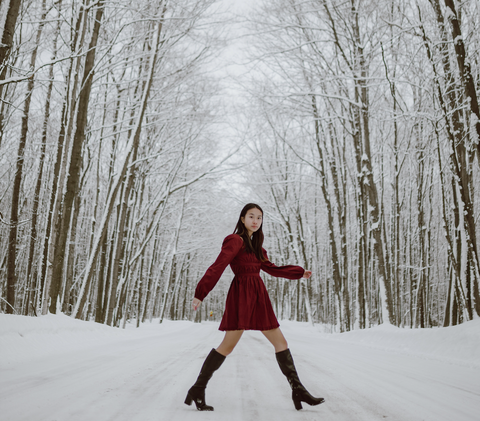Women walking in the snow wearing designer boots.