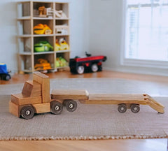 Handmade wooden toy truck for kids, crafted from solid pine wood. Durable and long-lasting. Non-toxic finish ensures child safety.