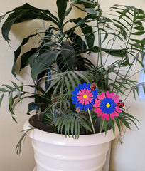 Two wooden daisies with ladybugs petite plant stakes.