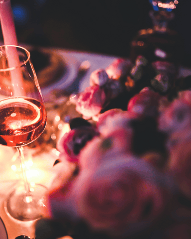 valentine's day flowers and a wine glass cup and candles