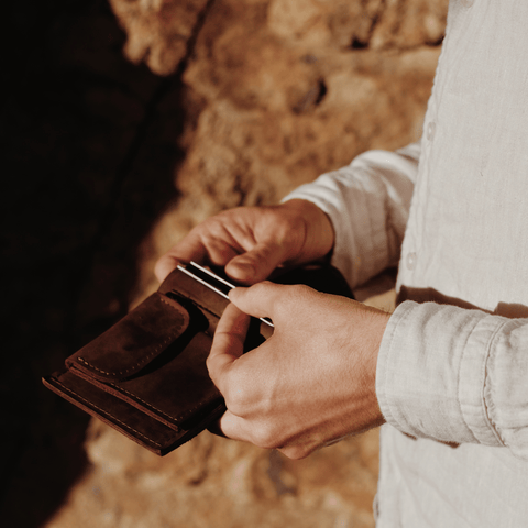 a man holding leather card holder 